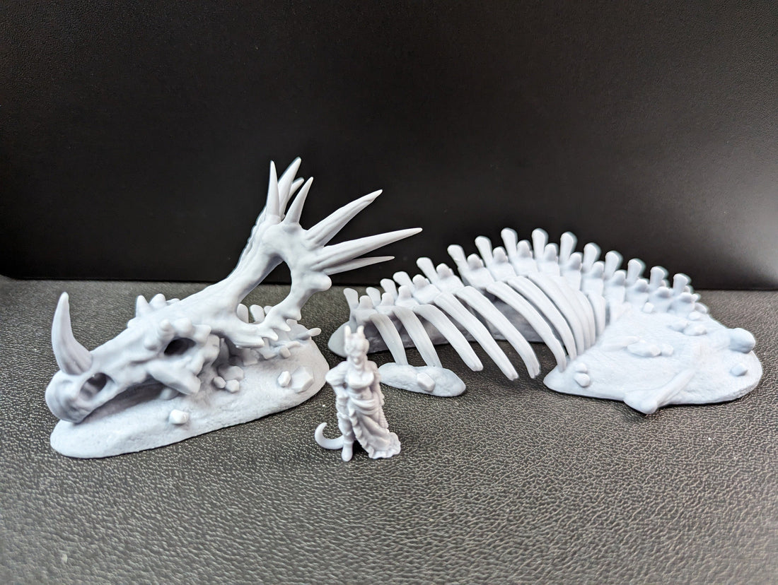 Ancient skeletal remains terrain by VesnaSculpts, with a smaller character miniature shown for scale