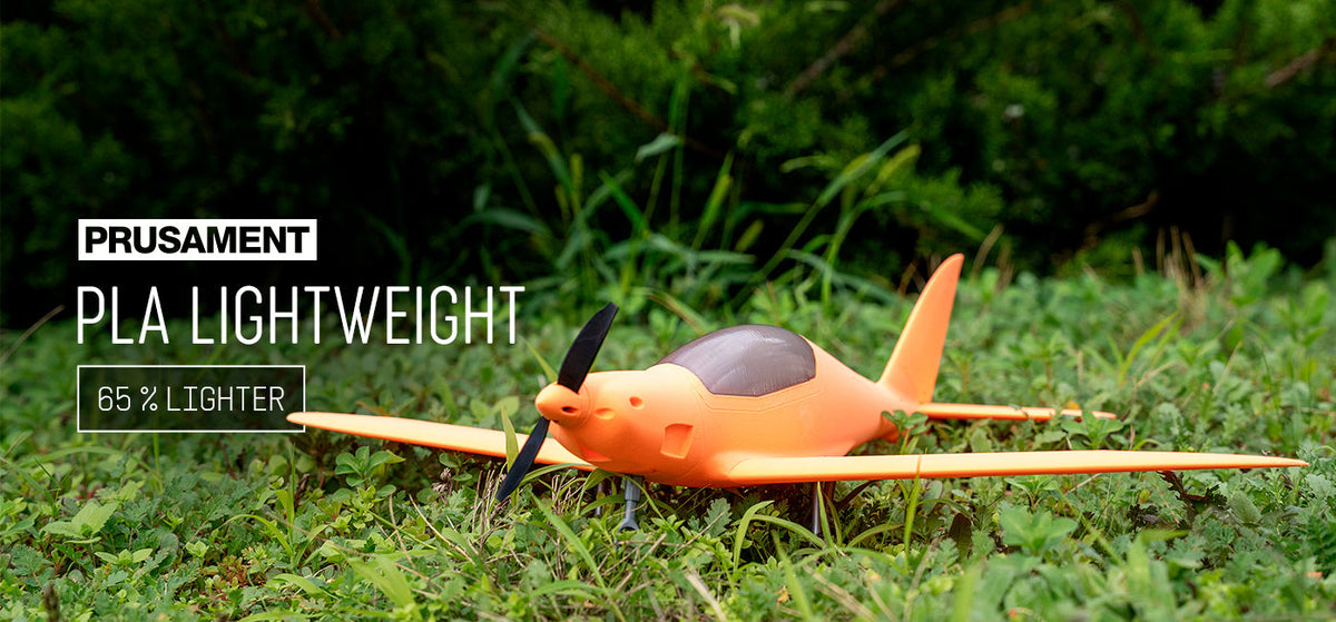 Prusa Research announcement image showing an orange model airplane made with Prusament PLA Lightweight