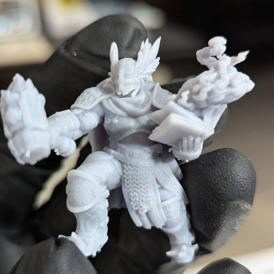 Unpainted fantasy hero miniature on the PrintedByAliens workbench